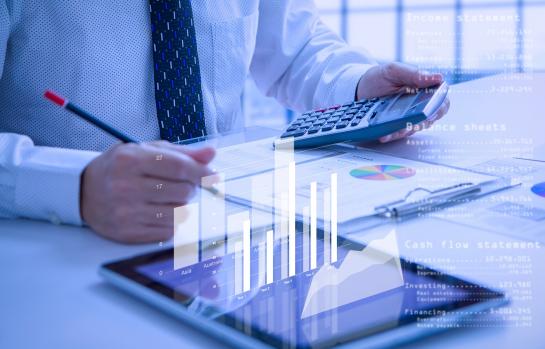 Businessman,Or,Analyst,Holding,Calculator,While,Reviewing,Financial,Statements,For