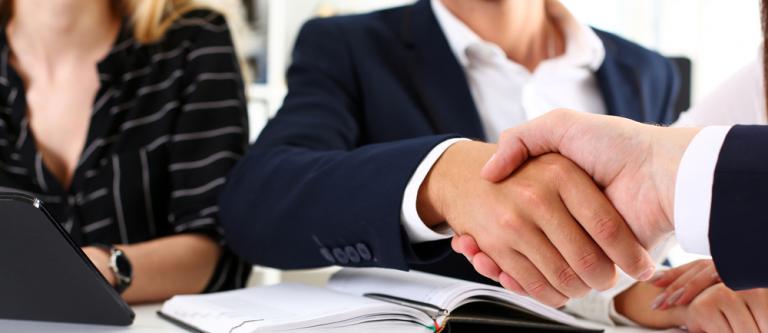 Man,In,Suit,Shake,Hand,As,Hello,In,Office,Closeup.