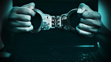 Boy,Hodling,Handcuff,With,Laptop,Behind,,Cyber,Crime,Concept