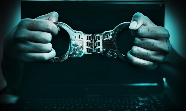Boy,Hodling,Handcuff,With,Laptop,Behind,,Cyber,Crime,Concept