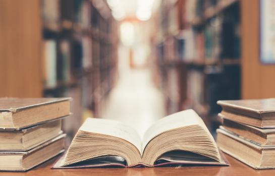 Old,Book,In,Library,With,Open,Textbook,,Stack,Piles,Of