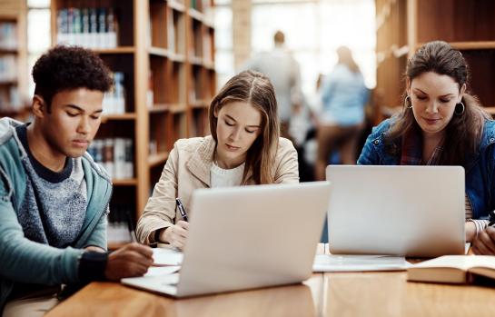 Laptop,,Research,And,Students,Learning,At,College,Library,For,Education,