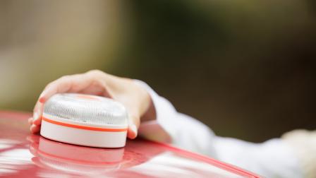 Young,Woman,With,Reflective,Vest,,Places,The,V16,Emergency,Light